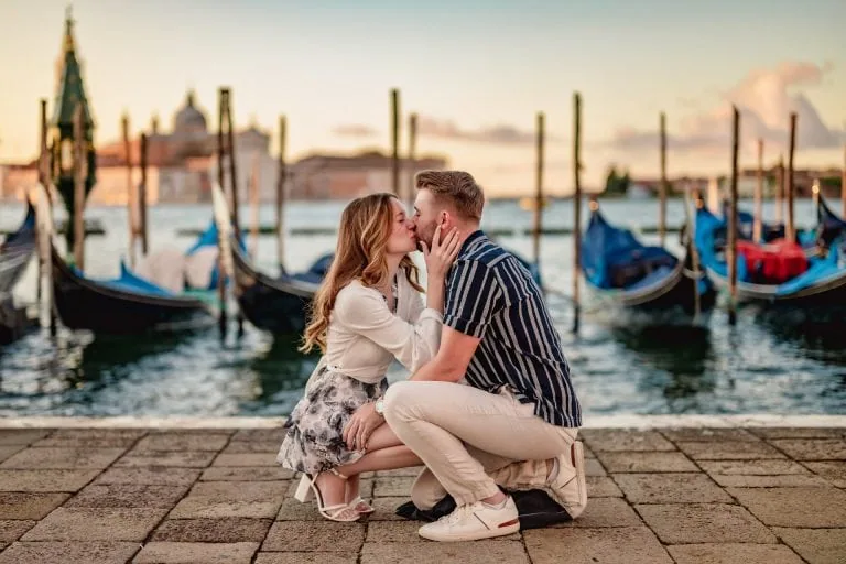 A man on one knee proposing on the Riva degli Schiavoni, with views of the Grand Canal – best proposal Venice moment.