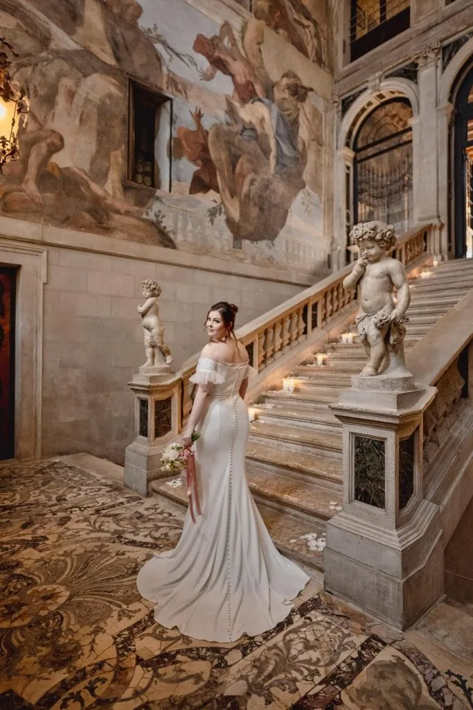 Bride getting ready in luxurious Ca’ Sagredo suite for Venice elopement