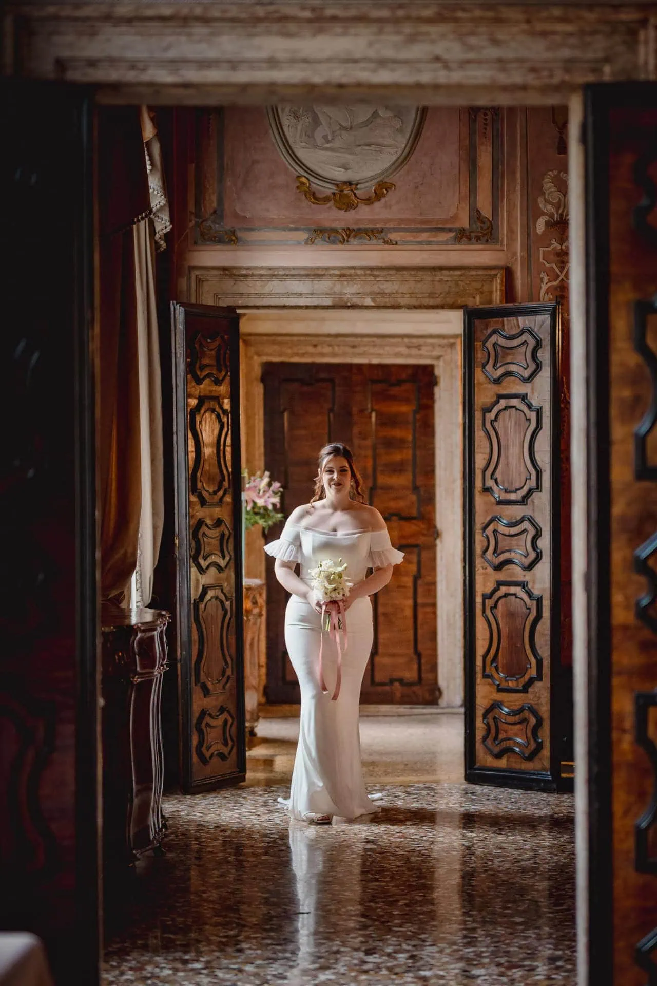 Bride getting ready in luxurious Ca’ Sagredo suite for Venice elopement