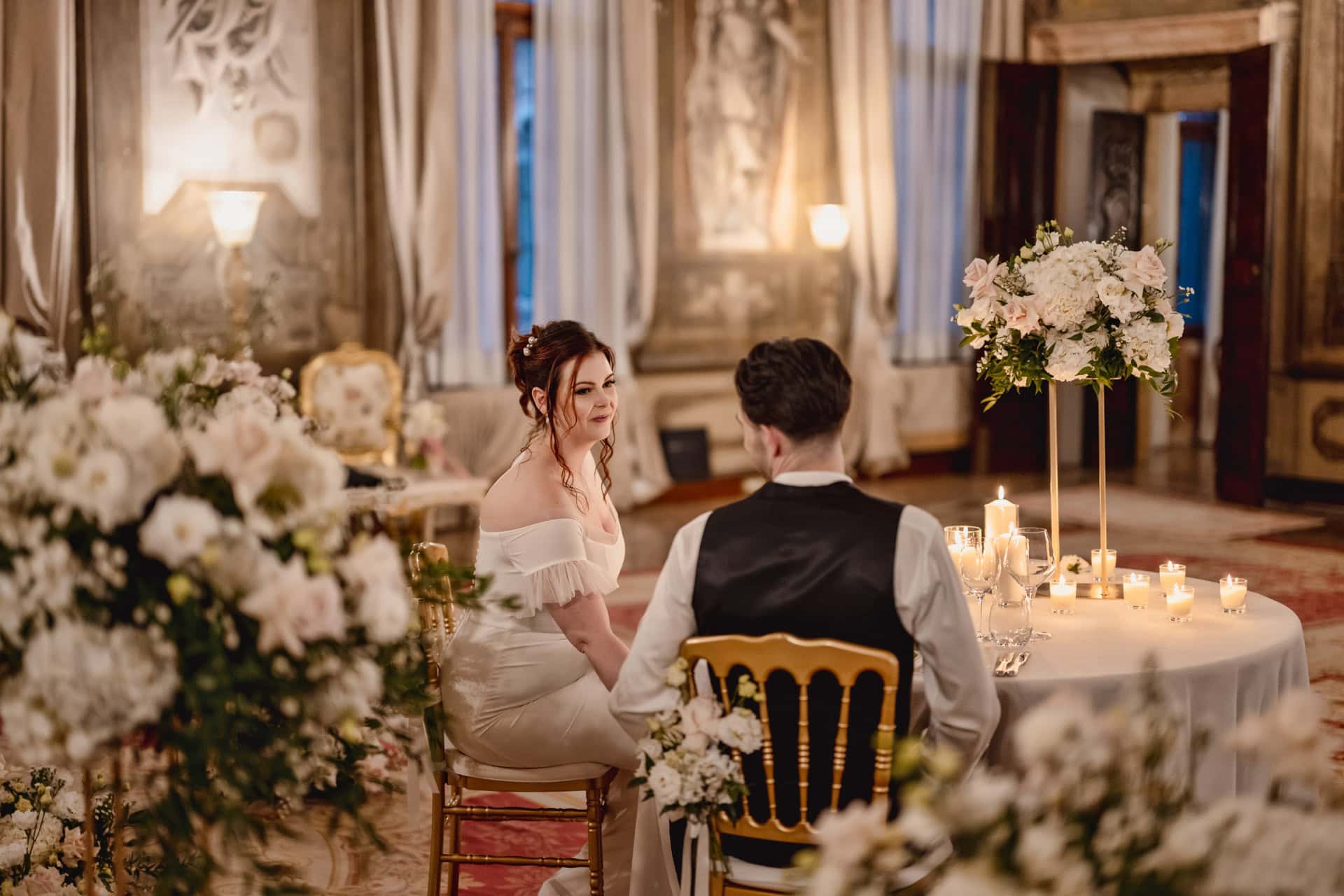 Couple having candlelit dinner at Ca’ Sagredo Hotel Venice after elopement