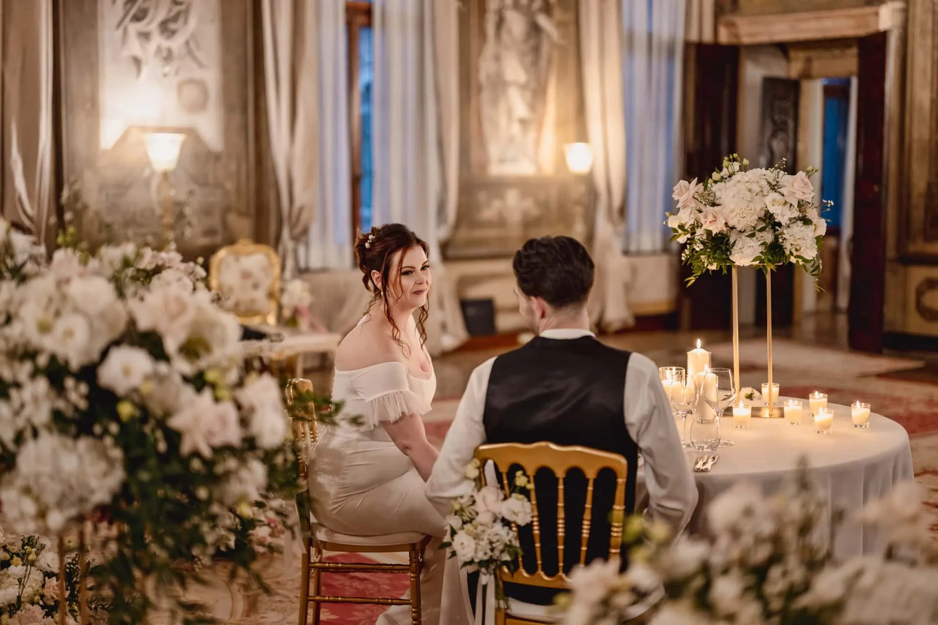 Couple having candlelit dinner at Ca’ Sagredo Hotel Venice after elopement