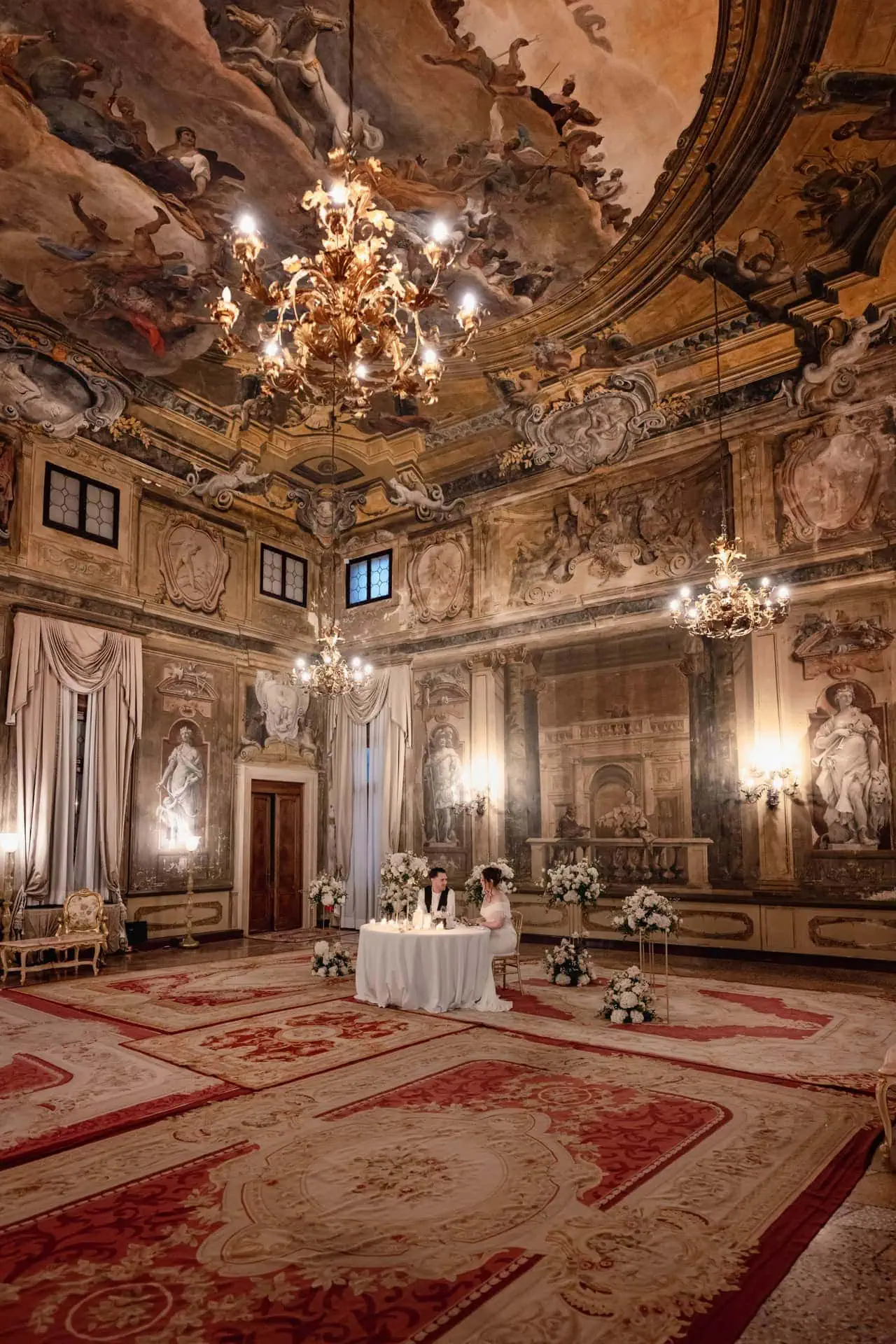 Couple having candlelit dinner at Ca’ Sagredo Hotel Venice after elopement