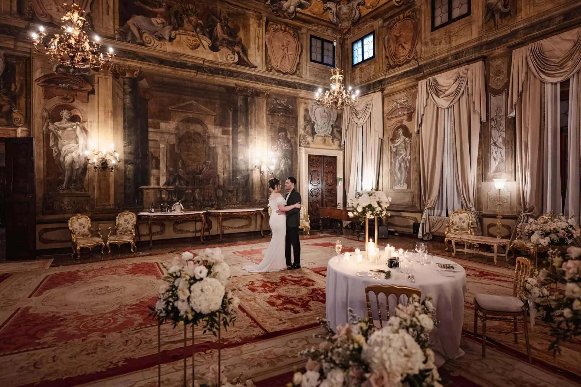 Couple having candlelit dinner at Ca’ Sagredo Hotel Venice after elopement