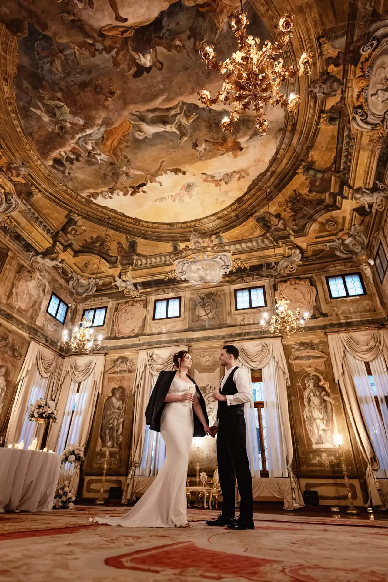 Couple having candlelit dinner at Ca’ Sagredo Hotel Venice after elopement
