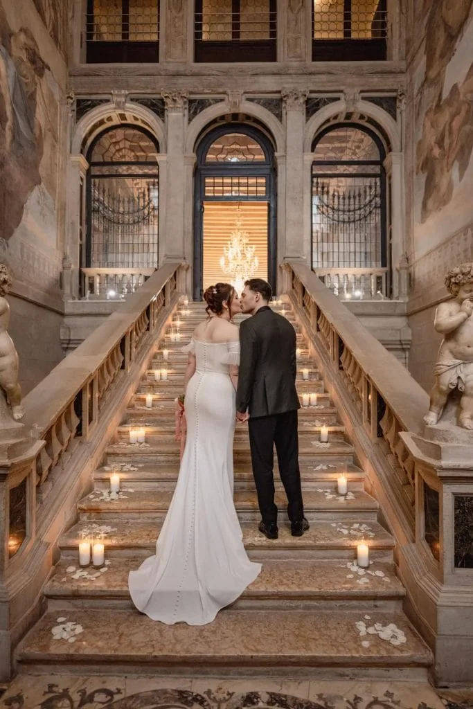 Bride and groom on the grand staircase of Ca’ Sagredo for wedding photos in Venice