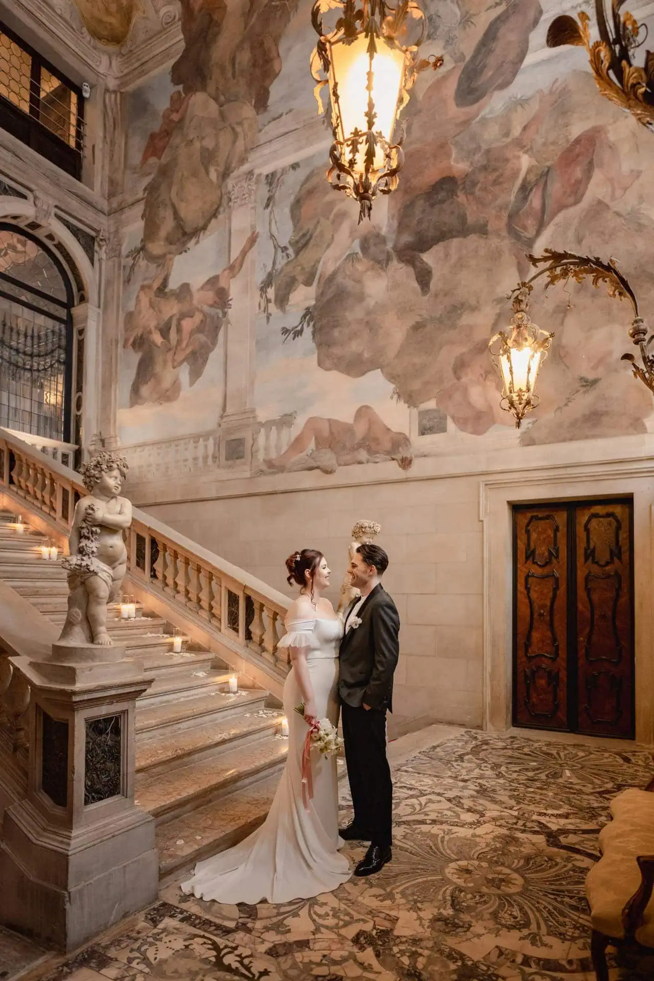 Couple enjoying Venice wedding photography on the grand staircase of Ca’ Sagredo for wedding photos in Venice