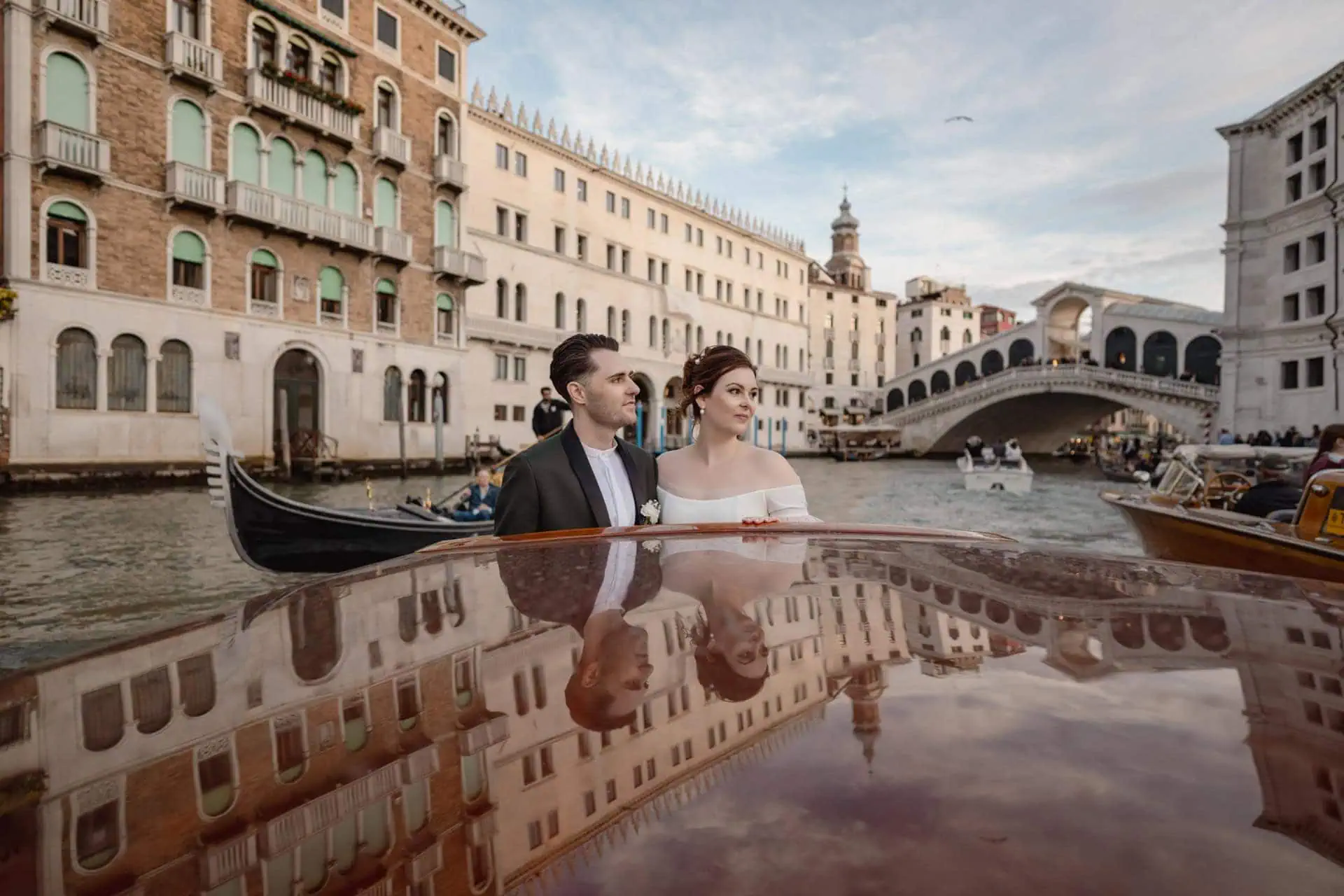 Couple passing in canal grande during taxi boat ride