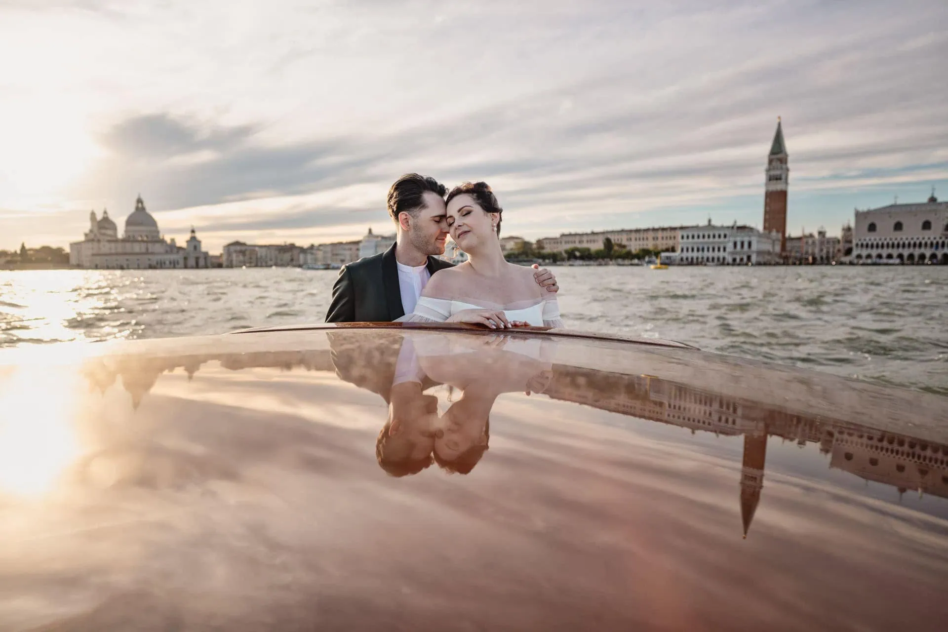 Couple passing in canal grande during taxi boat ride