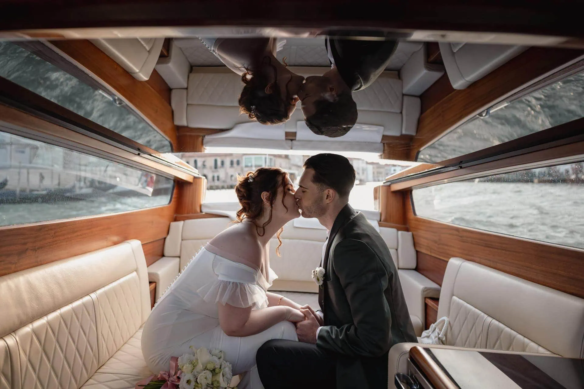 Couple passing in canal grande during taxi boat ride