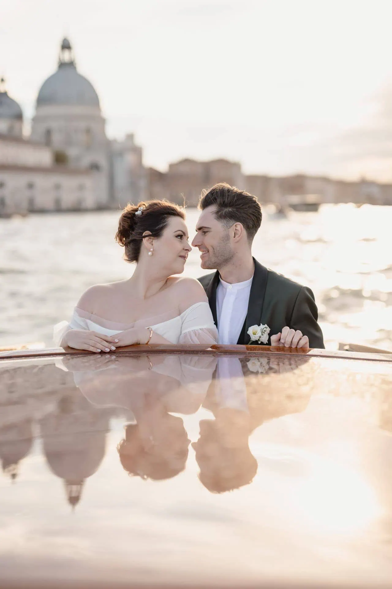 Couple passing in canal grande during taxi boat ride