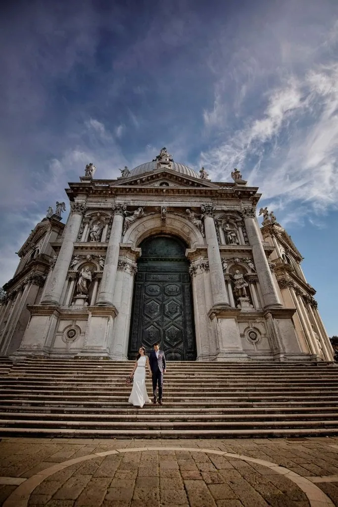 Elopement couple in front of the iconic Basilica di Santa Maria della Salute in Venice – Elopement Venice Wedding Photography.