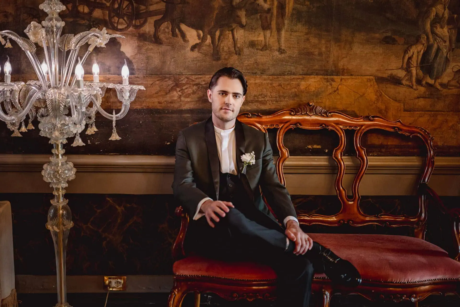 groom getting ready in luxurious Ca’ Sagredo suite for Venice elopement