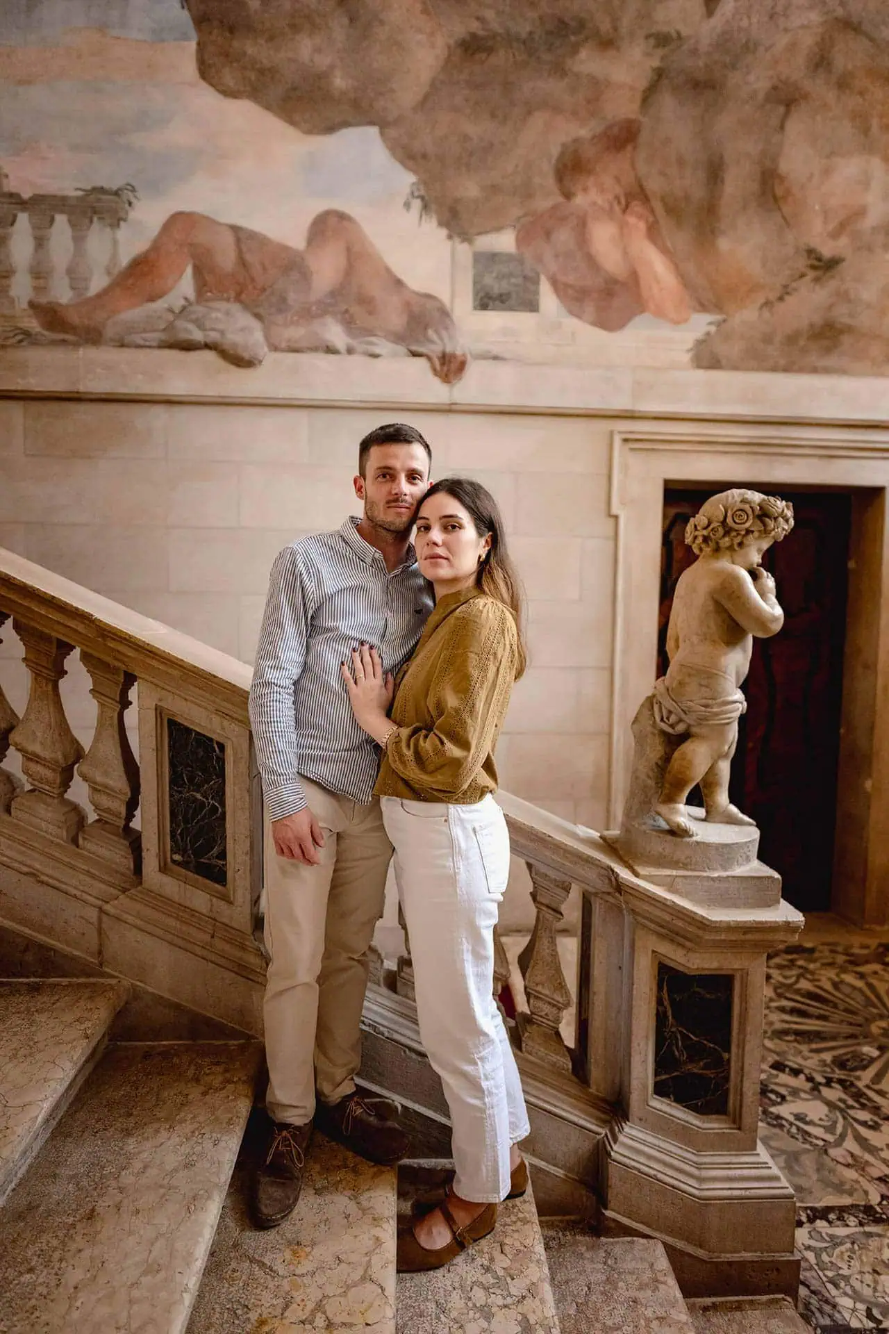 A newly engaged couple posing for romantic photos in a Venetian palace – proposal photography Venice.