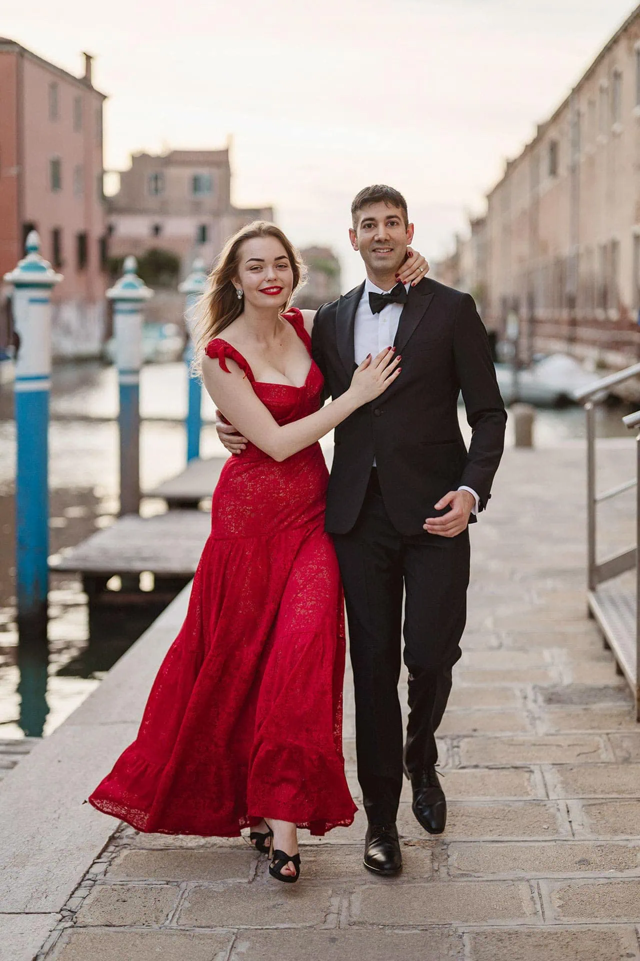A newly engaged couple walking along a canal in Venice – proposal photography Venice.