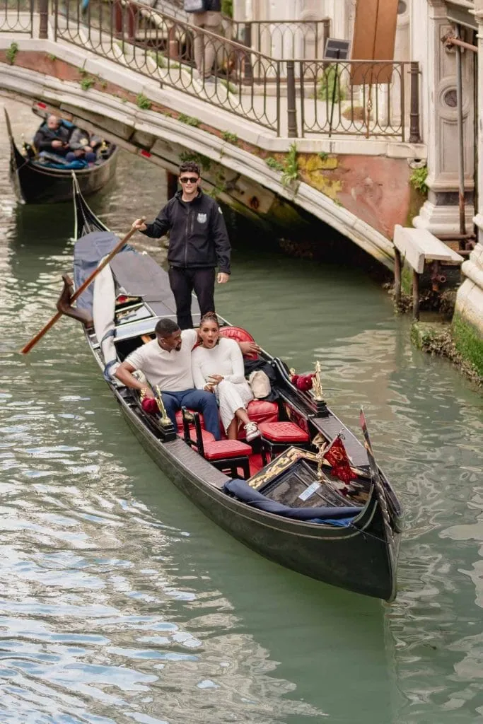 Surprise proposal on a gondola under the Bridge of Sighs – Venice engagement photography.