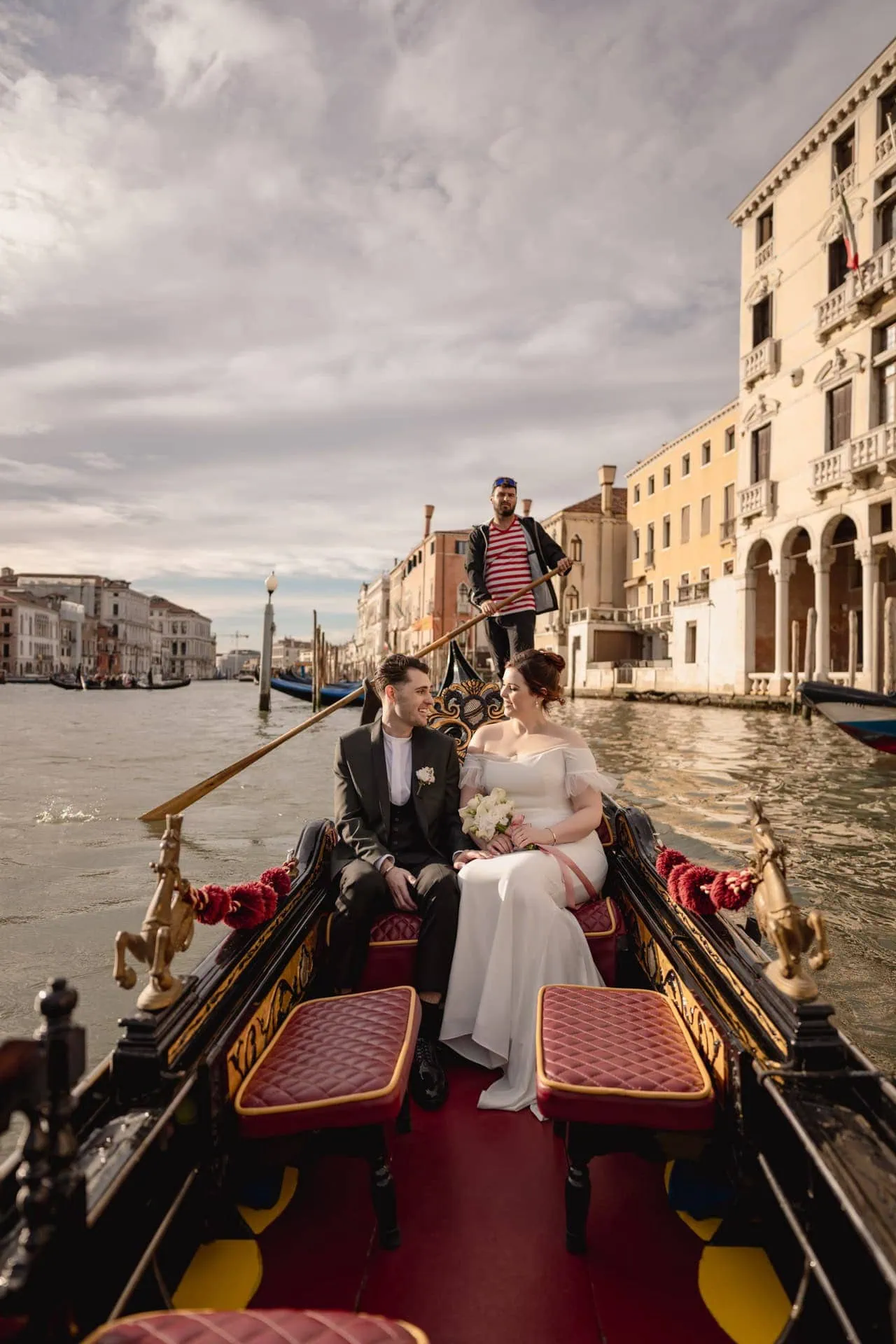 Couple on a gondola ride in Venice after their symbolic elopement ceremony