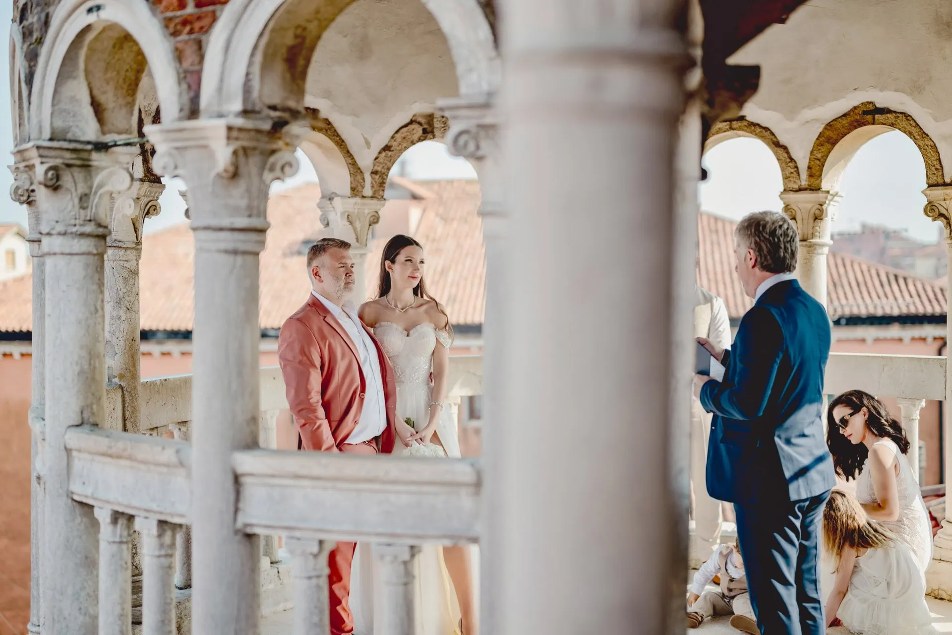 Venice wedding ceremony with couple and officiant on historic balcony in Italy.