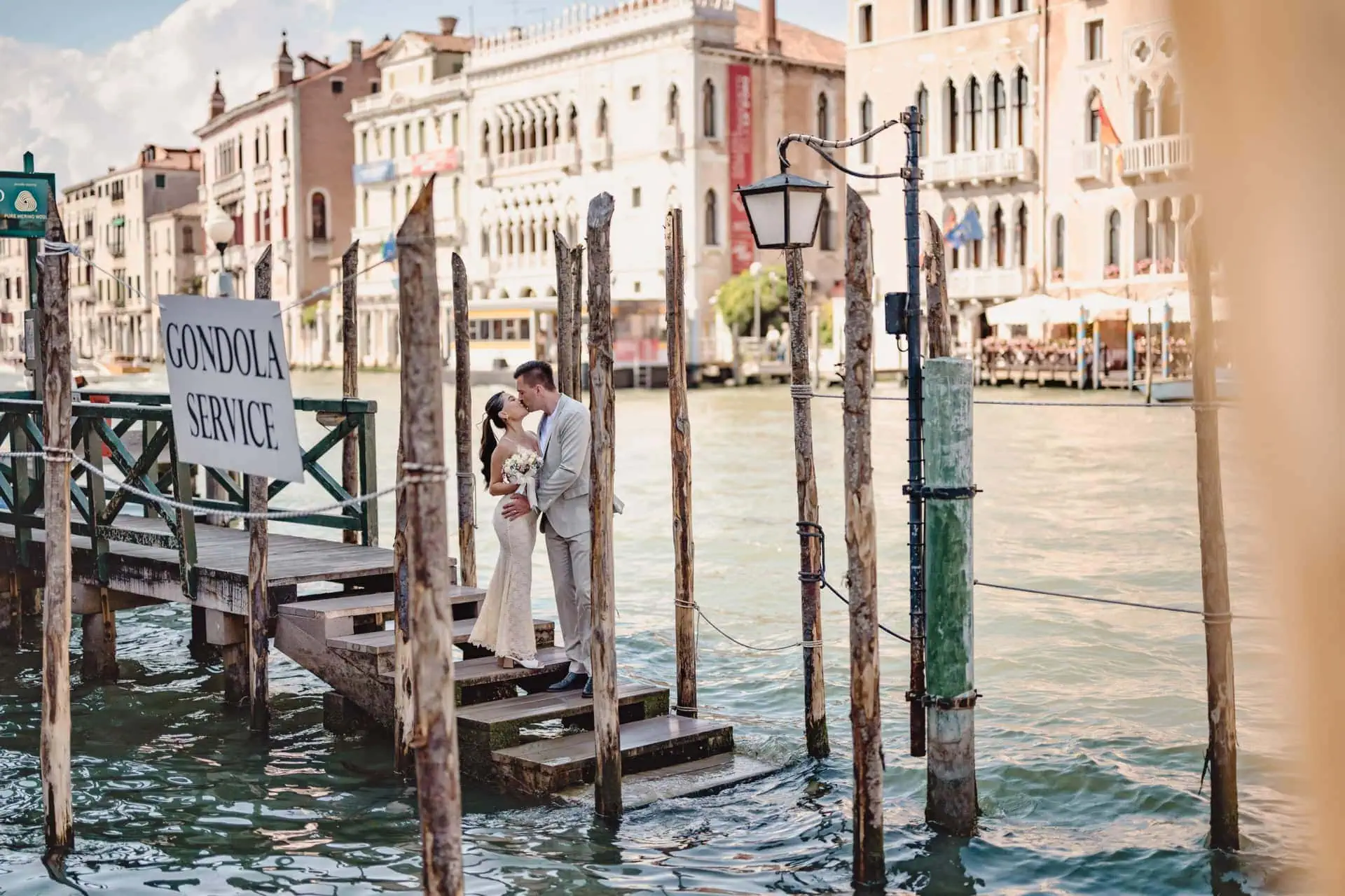 Couple laughing and walking hand in hand along a quiet Venetian alley – Candid engagement photos in Venice.