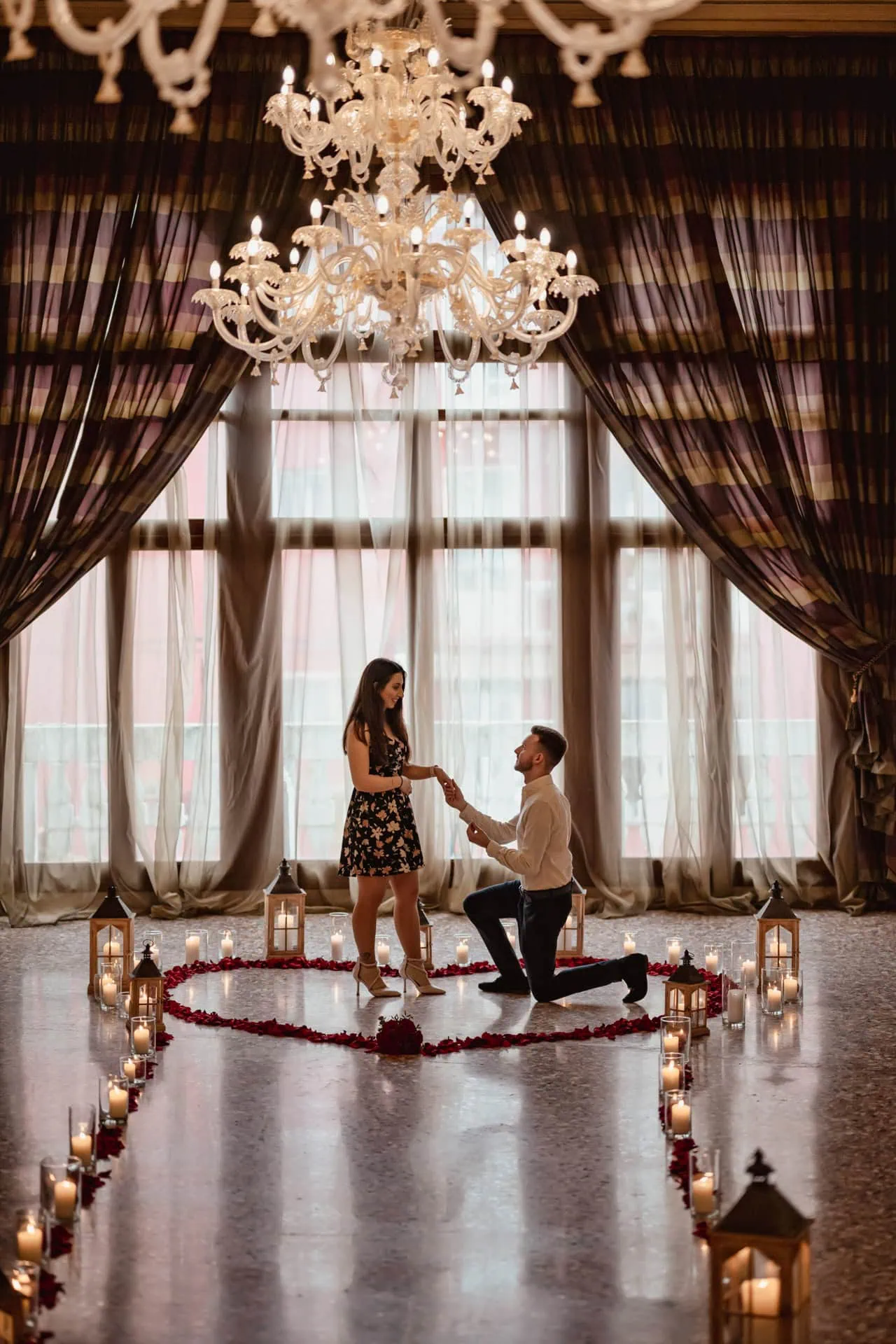 Man kneeling to propose at sunset in St. Mark’s Square – Romantic wedding proposal in Venice.