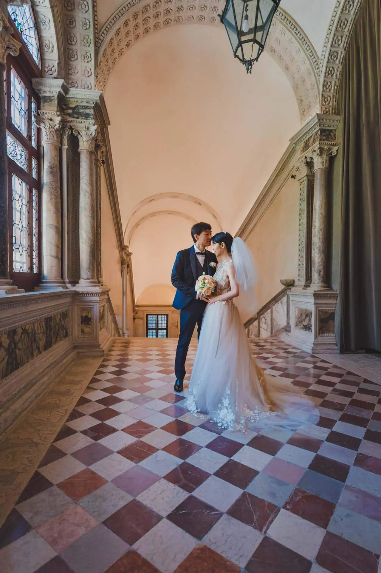 Couple enjoying Venice wedding photography posing for wedding photos in front of Scuola Grande San Giovanni Evangelista in Venice – wedding photography Venice.