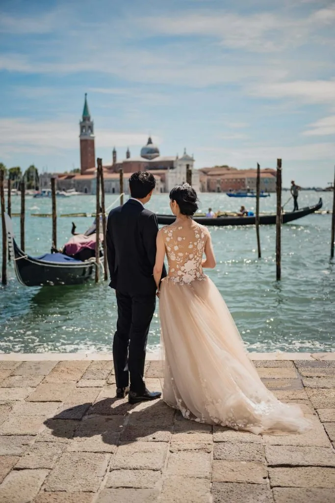 A newlywed couple gazing at the Grand Canal in Venice – venice photography wedding.