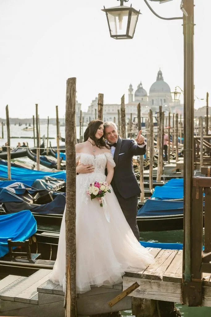 Wedding photography Venice - Couple by Grand Canal near gondolas