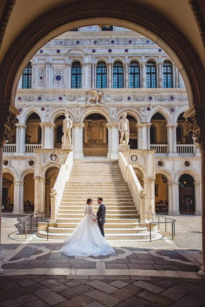 A couple posing romantically in the courtyard of the Doge's Palace in Venice – wedding photography Venice.