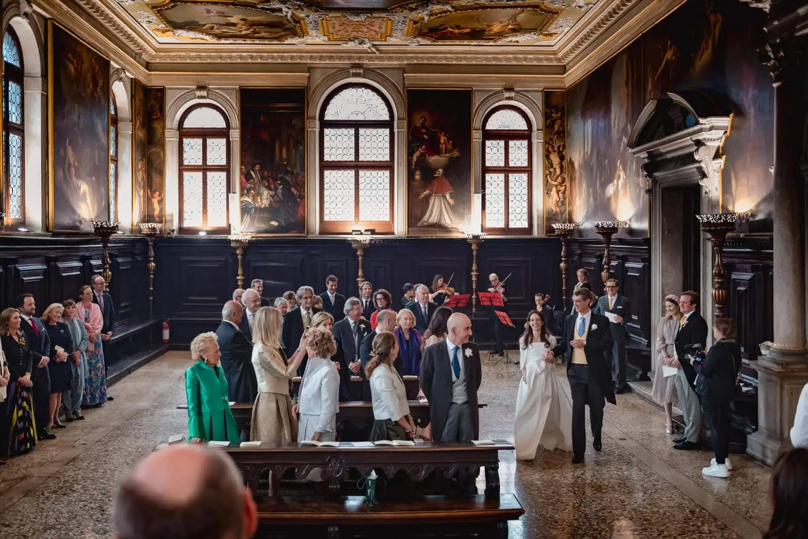 Stylish guest attire in Venice for a formal wedding.