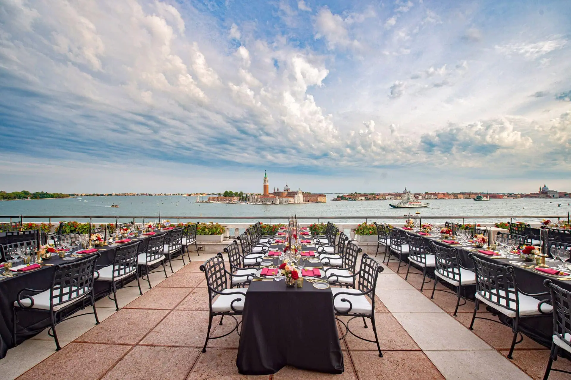 Elegant outdoor dining setup overlooking Venice canals, perfect for wedding celebrations and romantic proposals.
