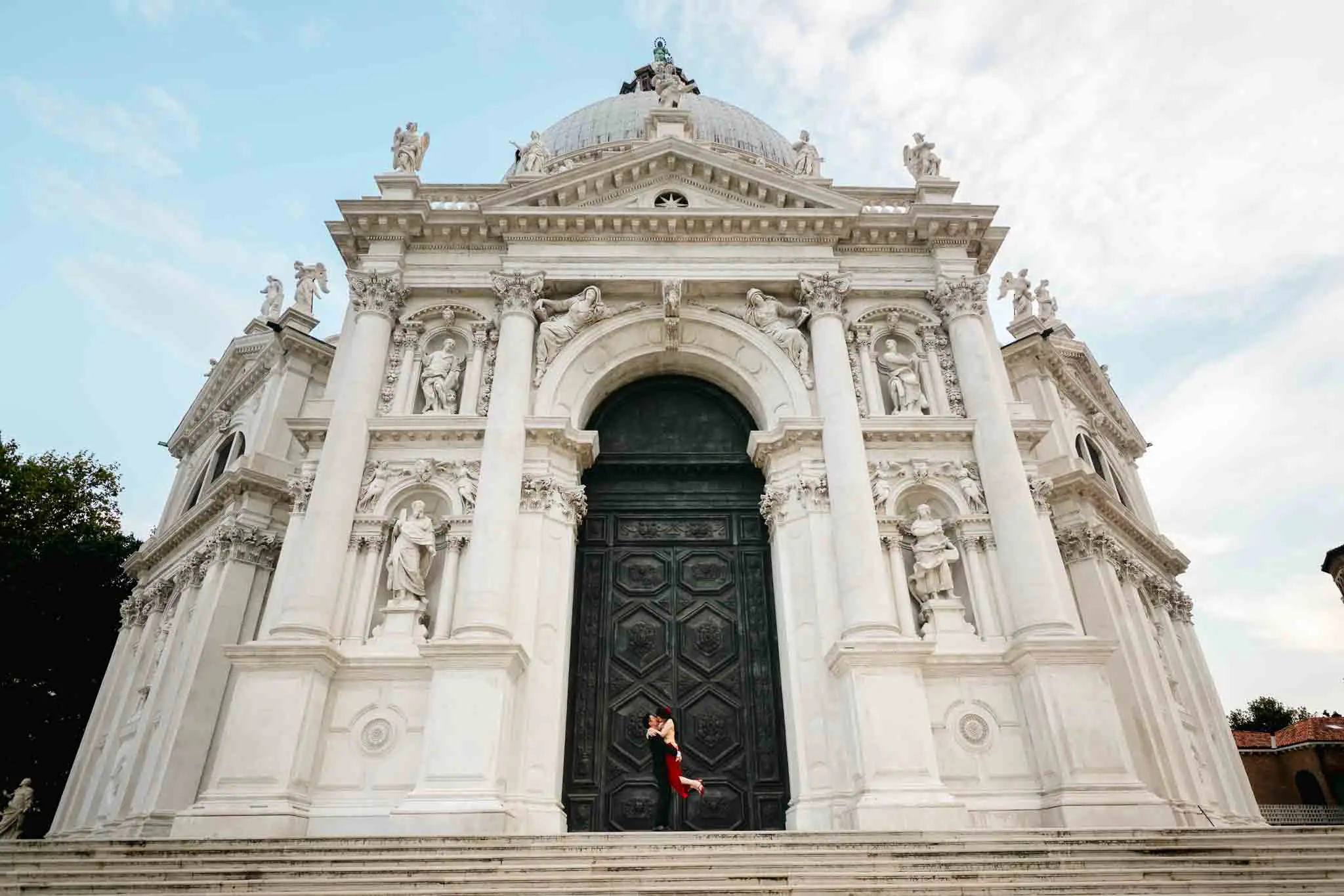 Couple embracing in front of basilica