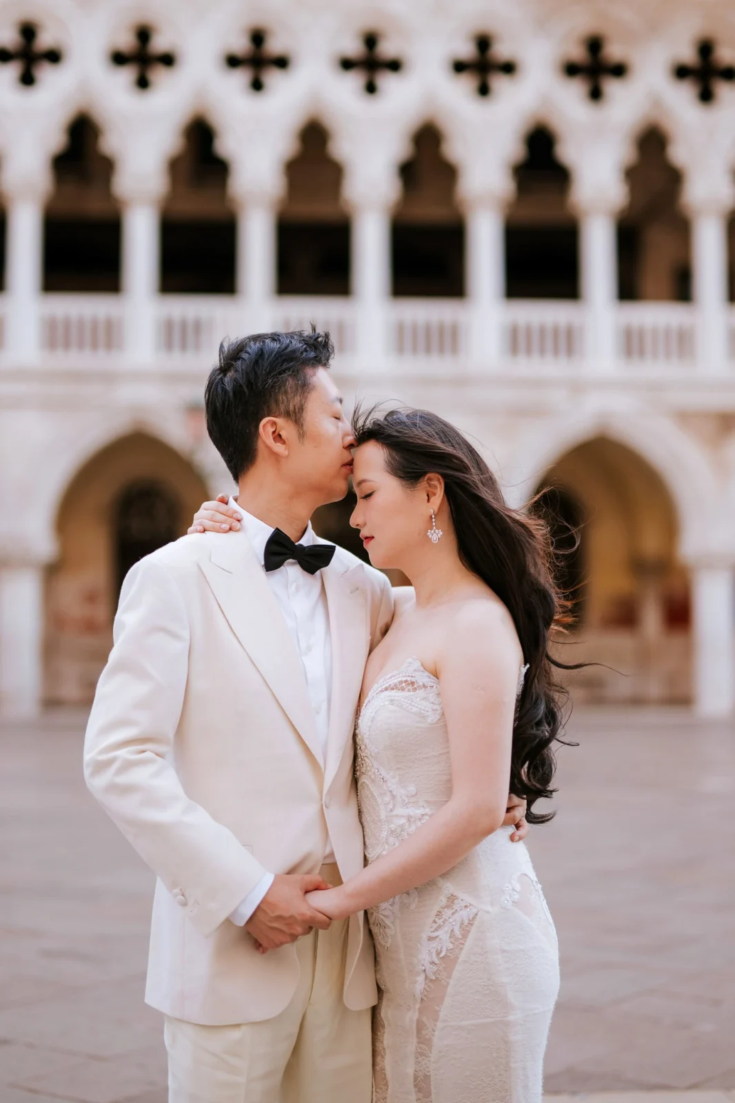Romantic wedding couple in Venice, Italy with historic architectural background.