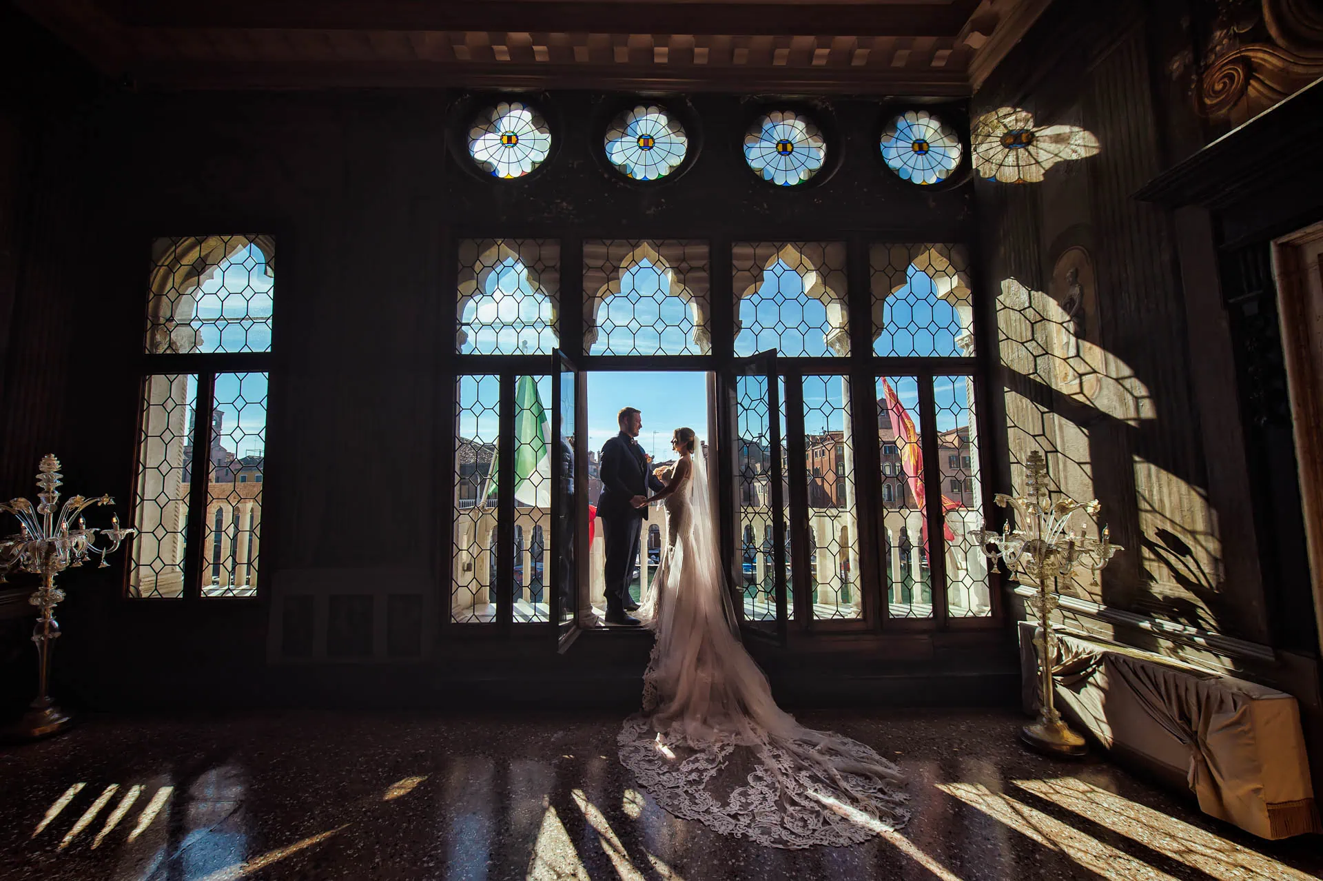 A couple during a symbolic wedding in Venice captured inside a luxurious private palace, surrounded by elegant decor.