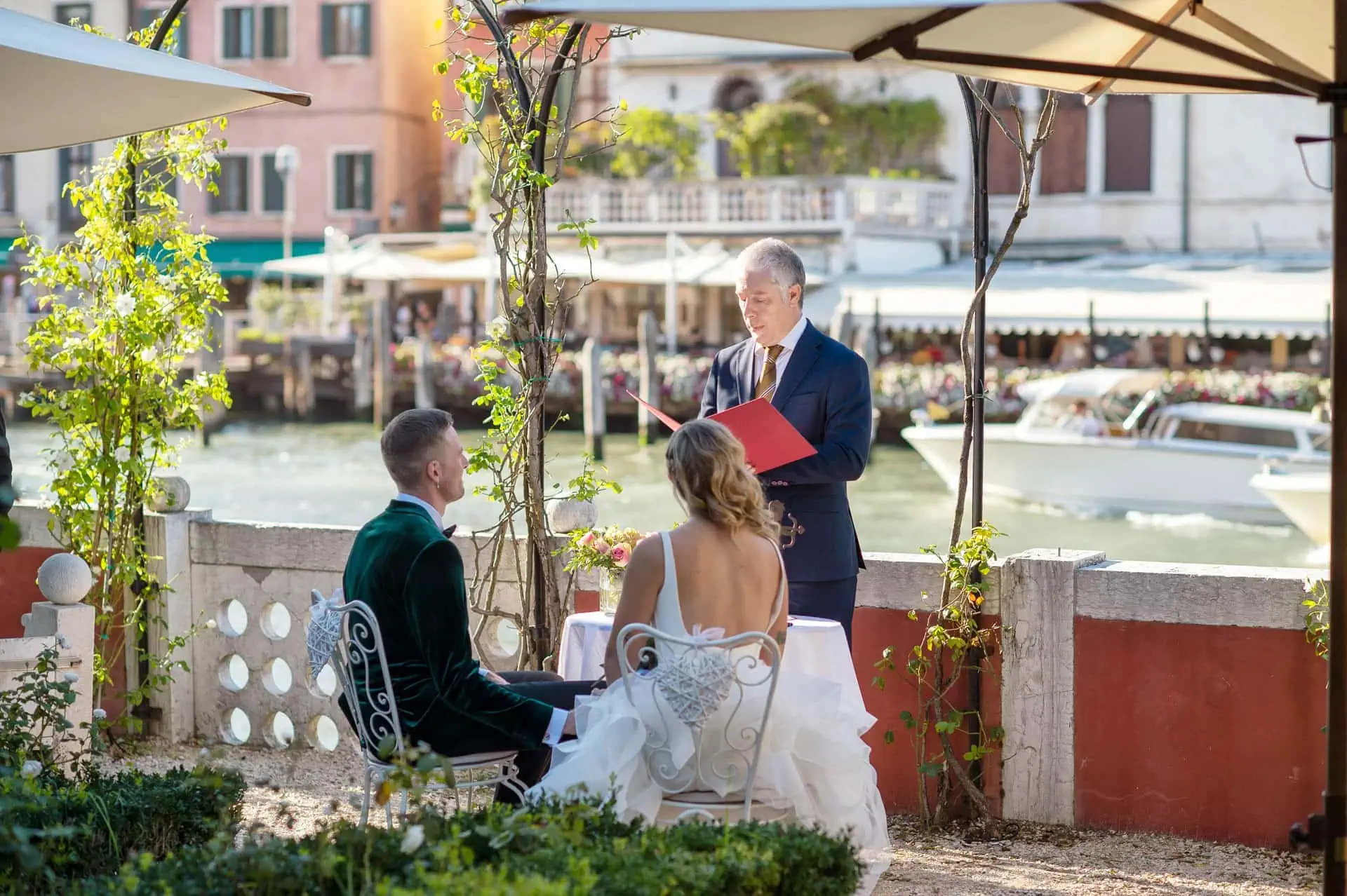 A couple during a symbolic wedding in Venice captured in the lush garden of a private palace.