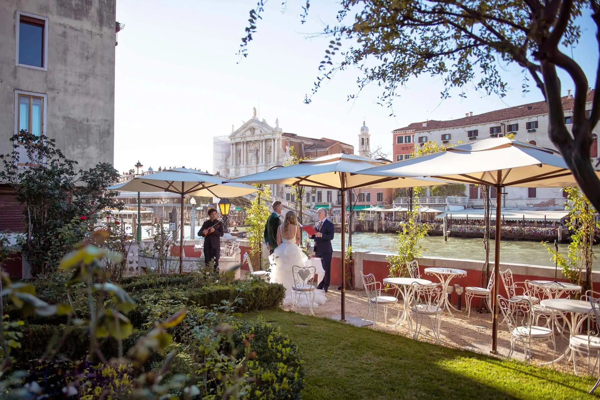 A couple during a symbolic wedding in Venice captured in the lush garden of a private palace.