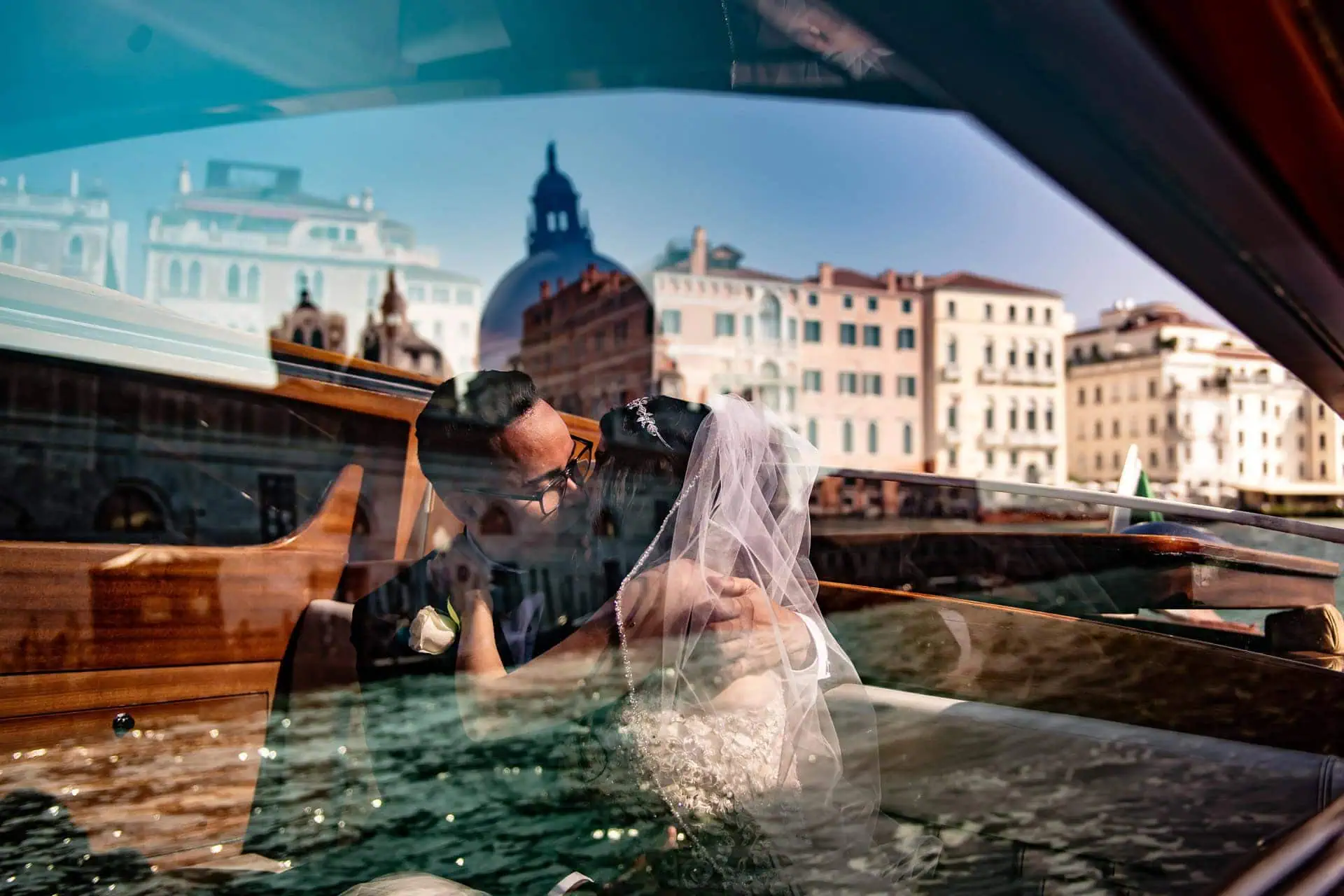 A couple during a symbolic wedding in Venice captured on a water taxi cruising along the Grand Canal.