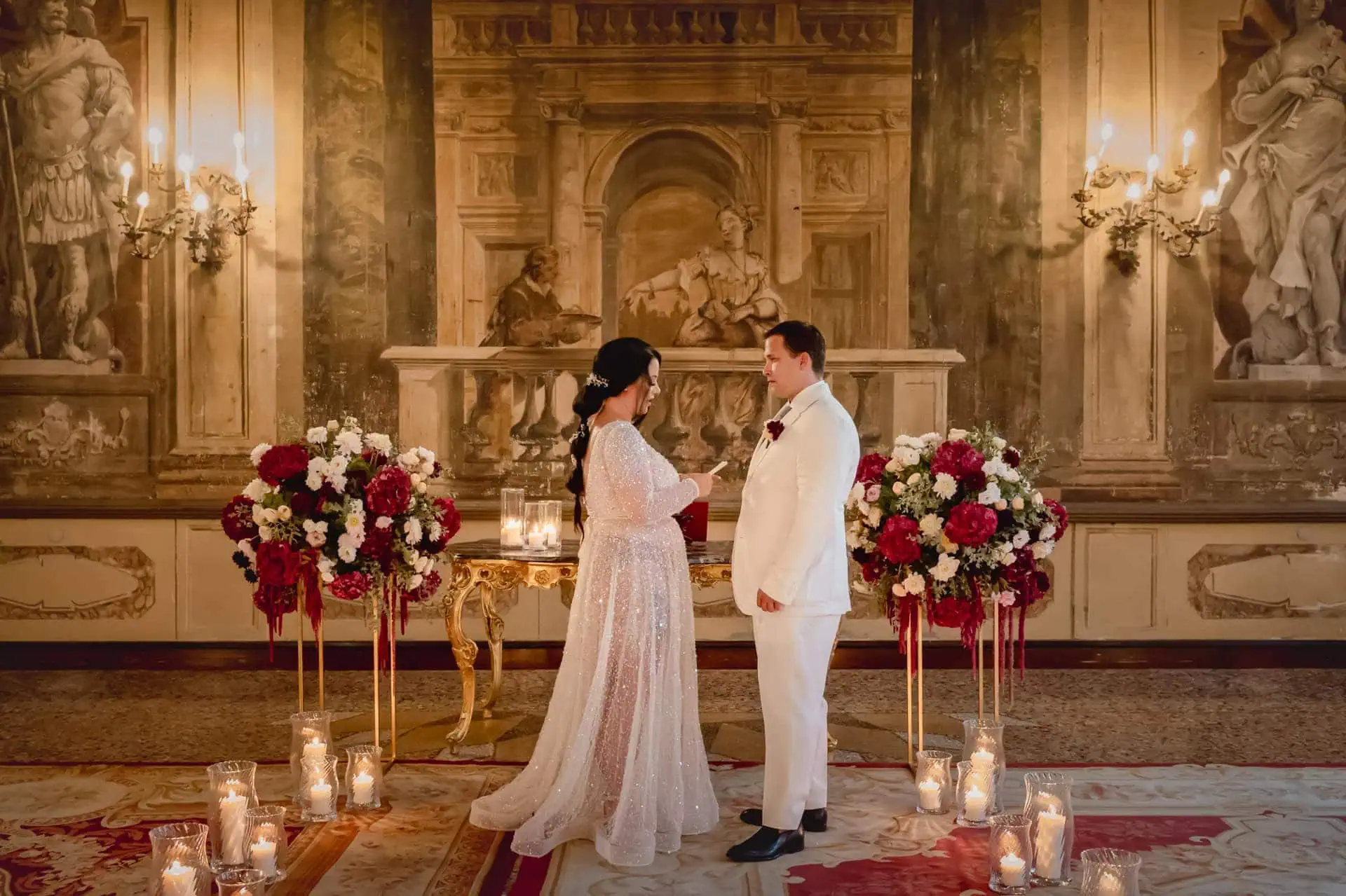 A couple during a symbolic wedding in Venice captured inside a luxurious private palace, surrounded by elegant decor.