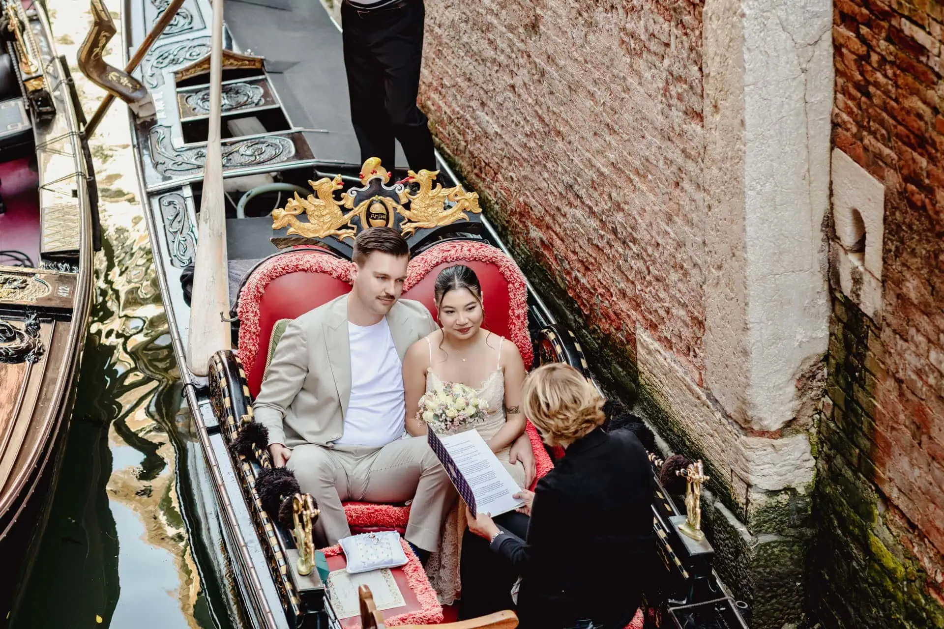 A couple during a symbolic wedding in Venice captured in a romantic gondola ride on the Grand Canal.