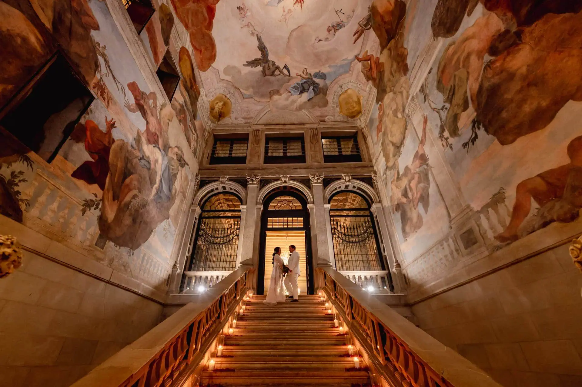 A couple during a symbolic wedding in Venice captured inside a luxurious private palace, surrounded by elegant decor.
