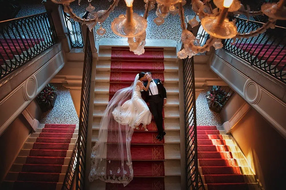 A couple during a symbolic wedding in Venice captured inside a luxurious private palace, surrounded by elegant decor.