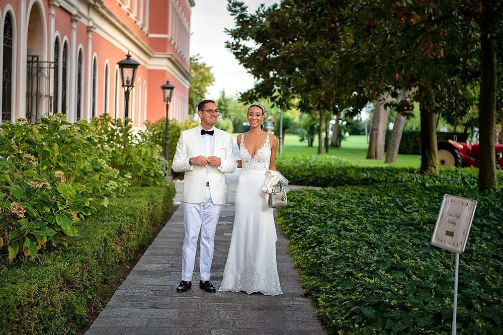 A couple during a symbolic wedding in Venice captured in the lush garden of a private palace.