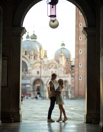 Engagement photo of a couple under the Doge’s Palace arches, a hidden gem for the best proposal Venice.