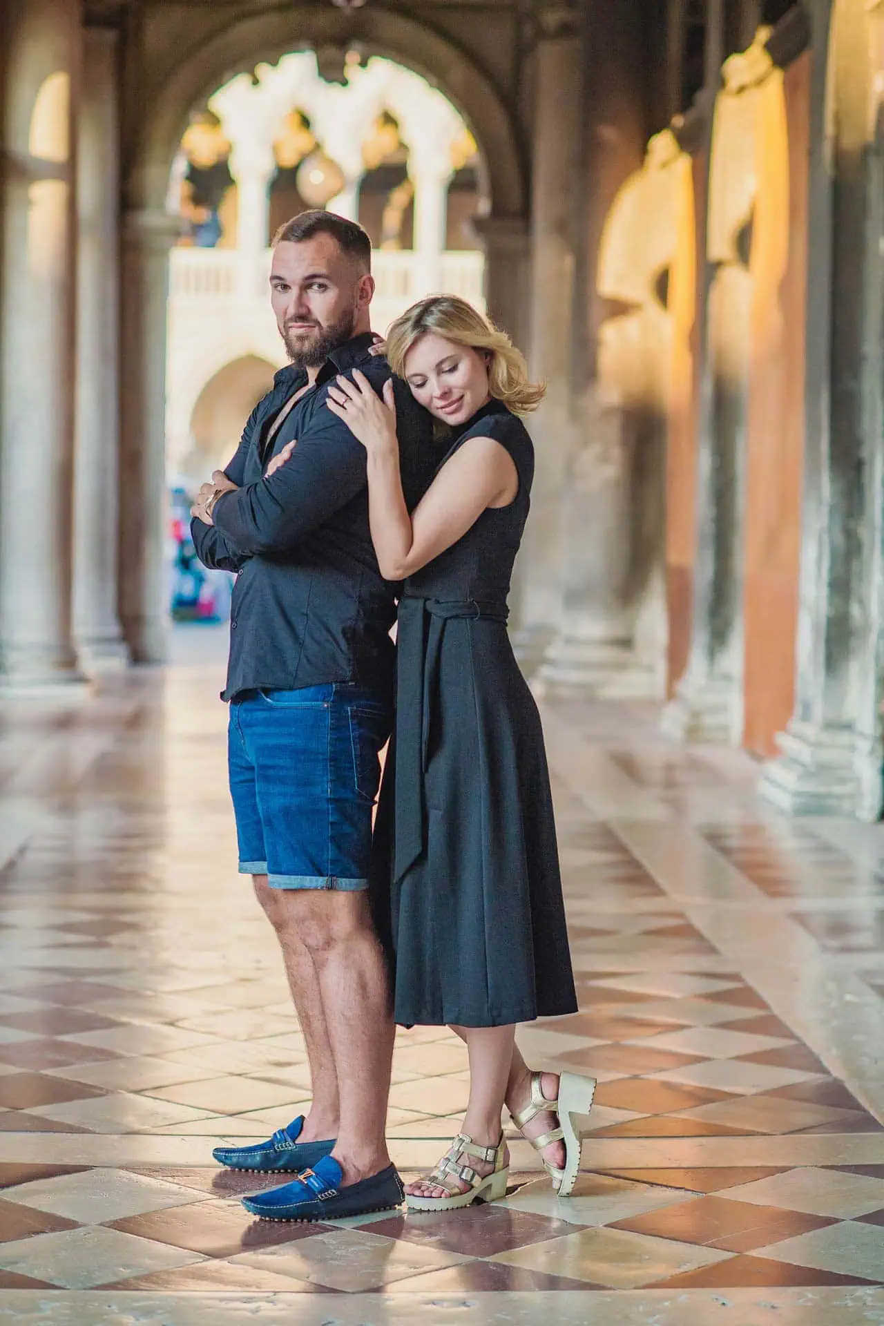 Engagement photo of a couple under the Doge’s Palace arches, a hidden gem for the best proposal Venice.