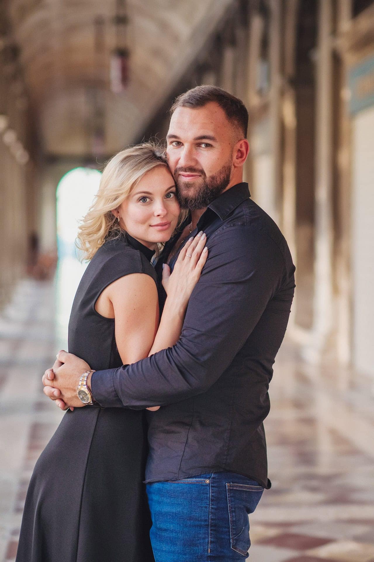Engagement photo of a couple under the Doge’s Palace arches, a hidden gem for the best proposal Venice.
