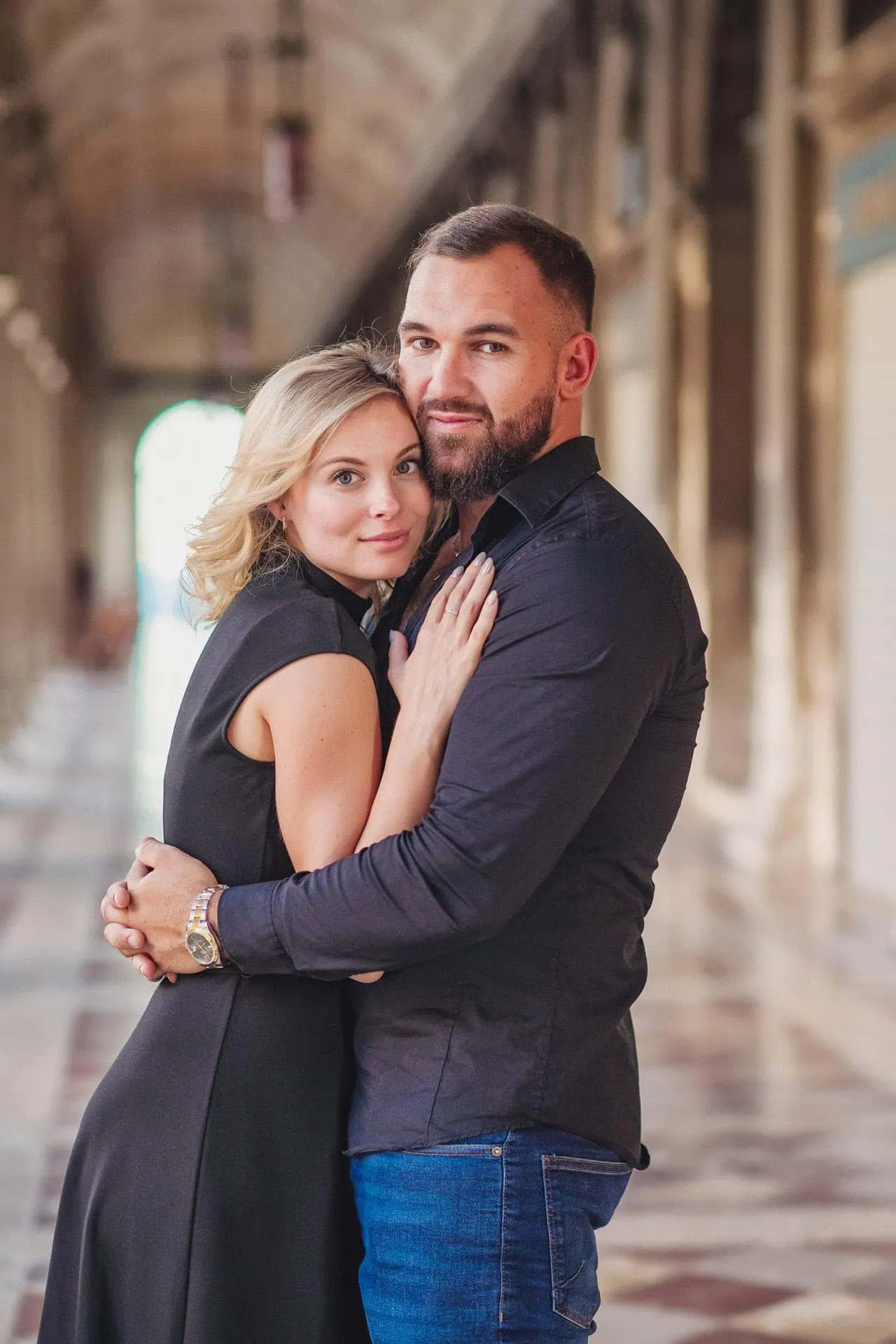 Engagement photo of a couple under the Doge’s Palace arches, a hidden gem for the best proposal Venice.