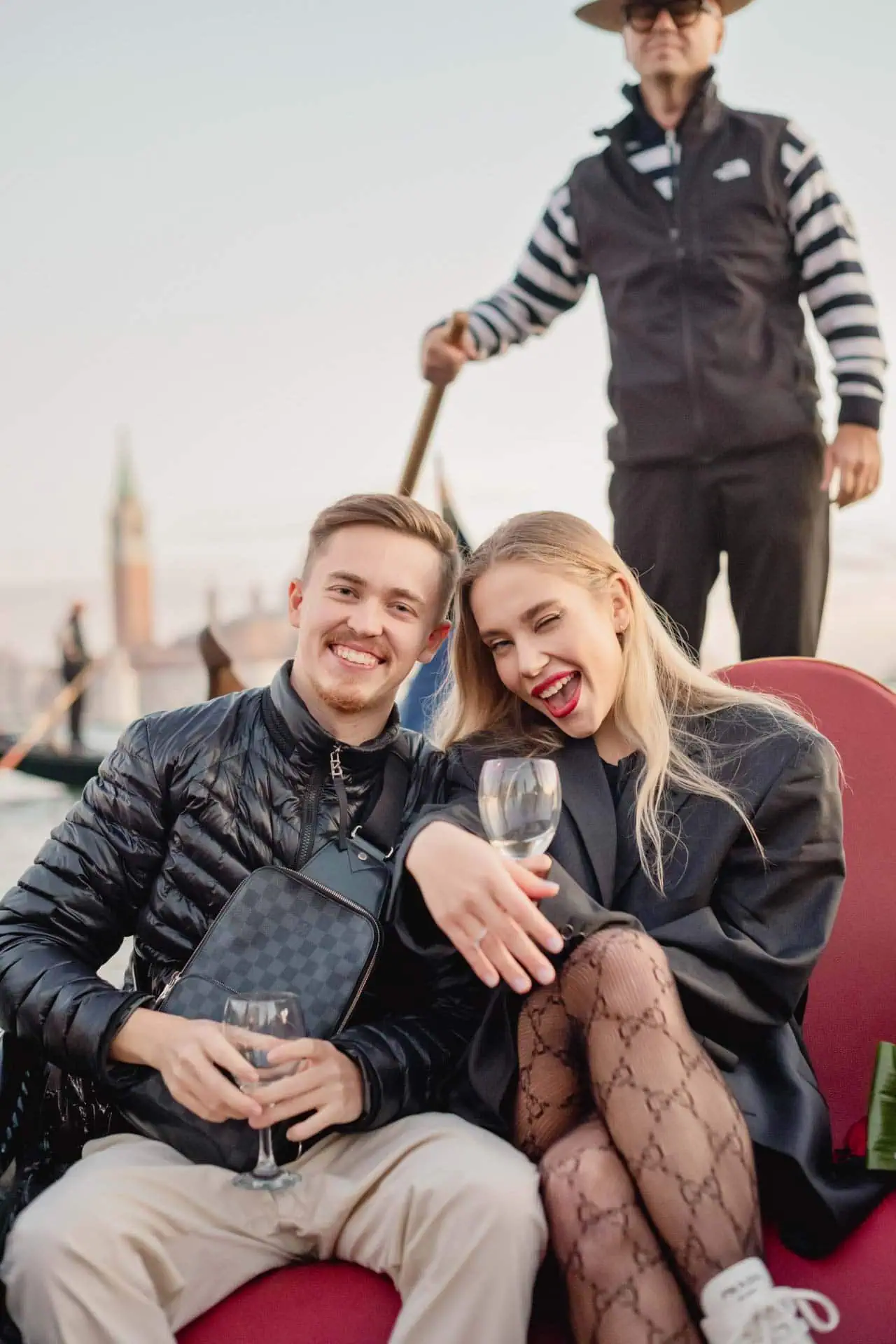 Couple on a gondola ride near San Marco, celebrating their engagement during the best proposal Venice session.