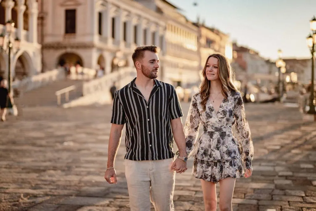 Couple during their engagement photoshoot at Piazza San Marco at sunrise, showcasing the best proposal Venice experience.