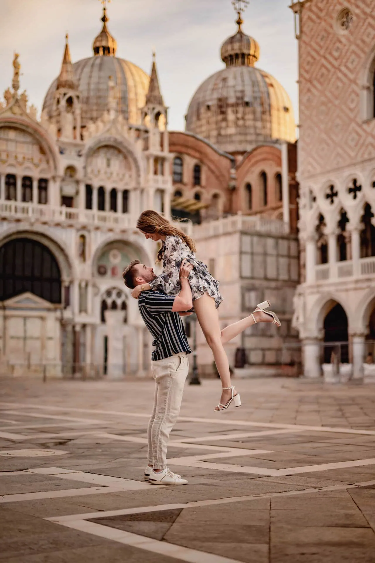 Couple during their engagement photoshoot at Piazza San Marco at sunrise, showcasing the best proposal Venice experience.