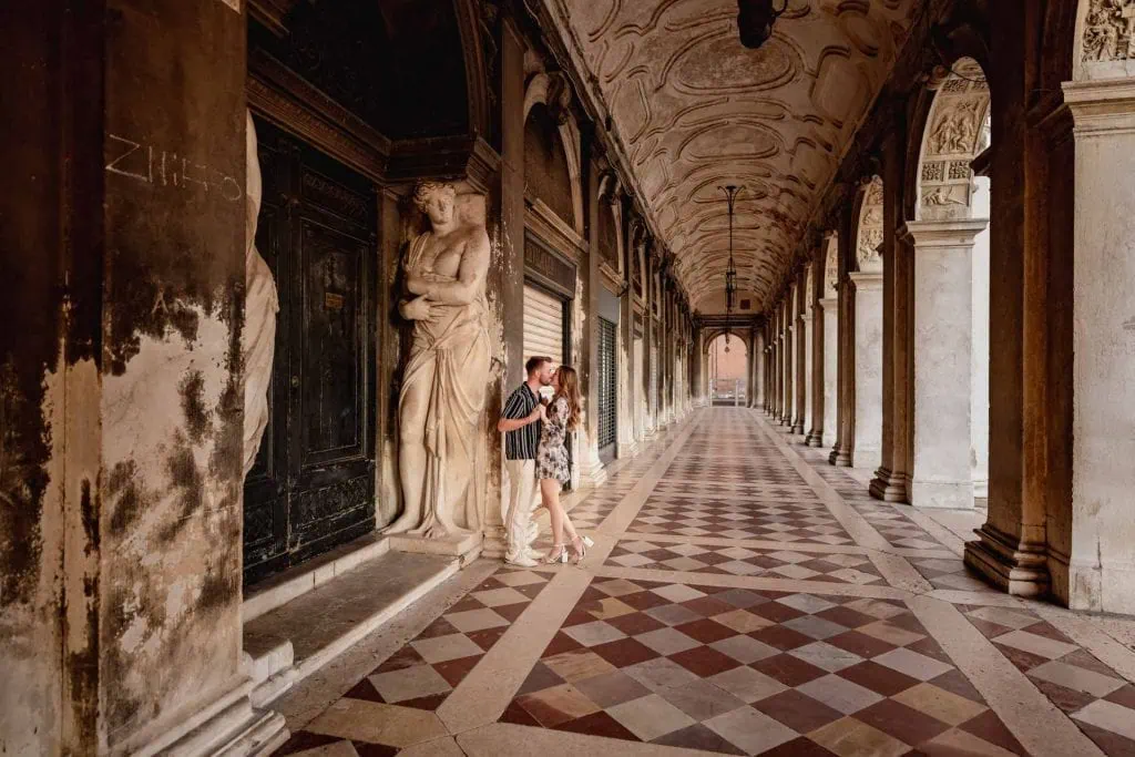 Couple during their engagement photoshoot at Piazza San Marco at sunrise, showcasing the best proposal Venice experience.