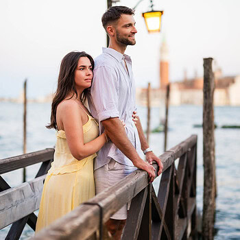 Venice couple portrait on wooden pier during sunset for engagement photoshoot.