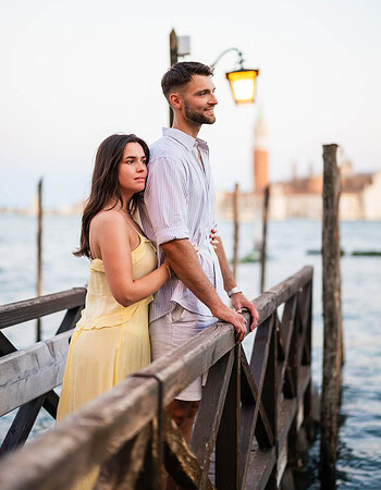 Venice couple portrait on wooden pier during sunset for engagement photoshoot.